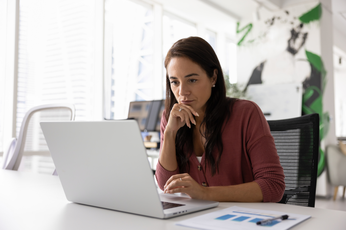 Thoughtful,Serious,Business,Project,Manager,Working,At,Laptop,In,Office,