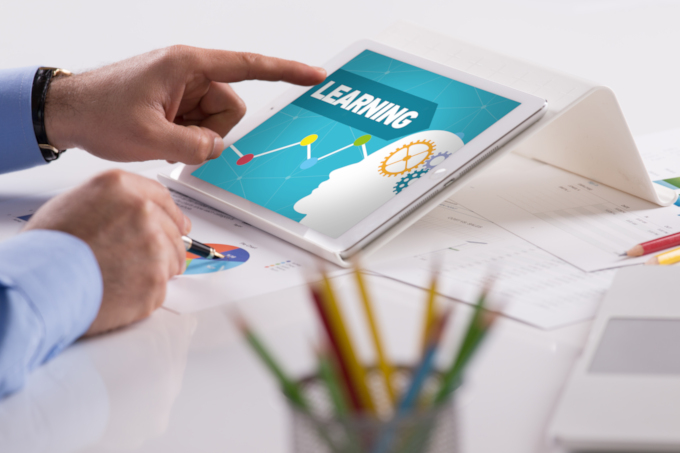 Businessman,Working,On,Tablet,With,Learning,On,A,Screen